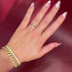 Oval solitaire with hidden halo and diamond bridge in yellow gold