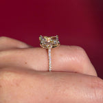 3.07ct F-VVS2 Radiant Lab Diamond Isabela. The Isabela is a cathedral style body with the key features being the pavé diamond lotus petal prongs and diamond bridge. This specific isabela is made with pavé side diamonds and is solid 14k yellow gold.