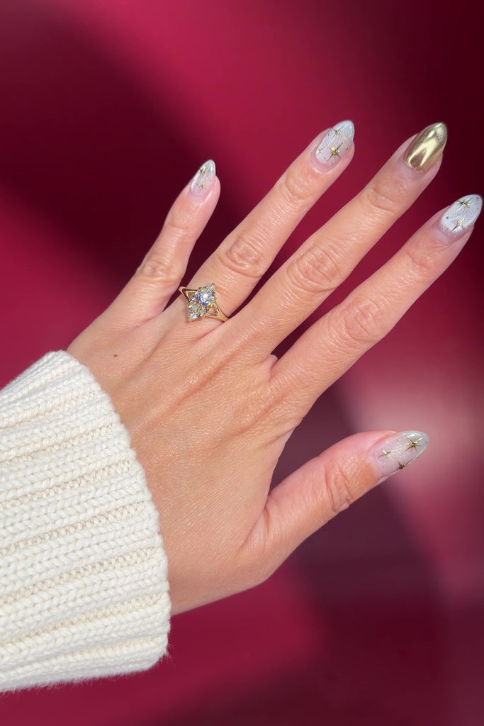 yellow gold marquise lab diamond solitaire split shank engagement ring on hand