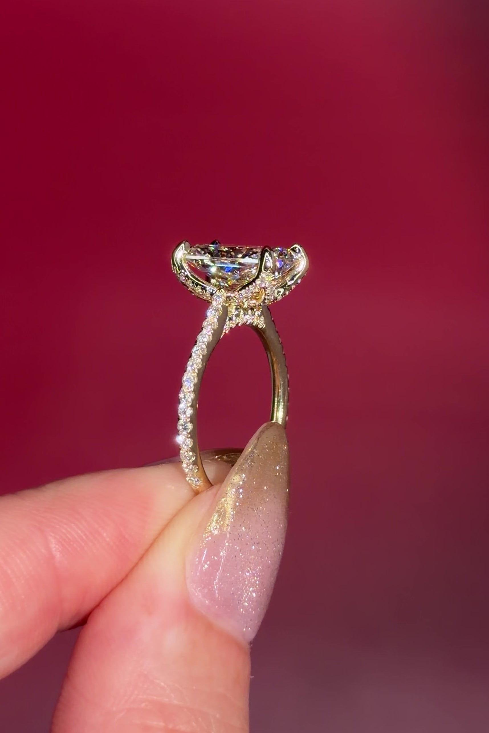 3.07ct F-VVS2 Radiant Lab Diamond Isabela. The Isabela is a cathedral style body with the key features being the pavé diamond lotus petal prongs and diamond bridge. This specific isabela is made with pavé side diamonds and is solid 14k yellow gold.