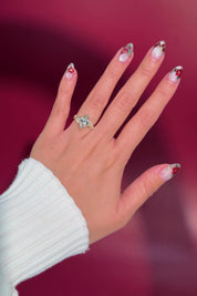 marquise diamond yellow gold engagement ring with alternating side stones on hand