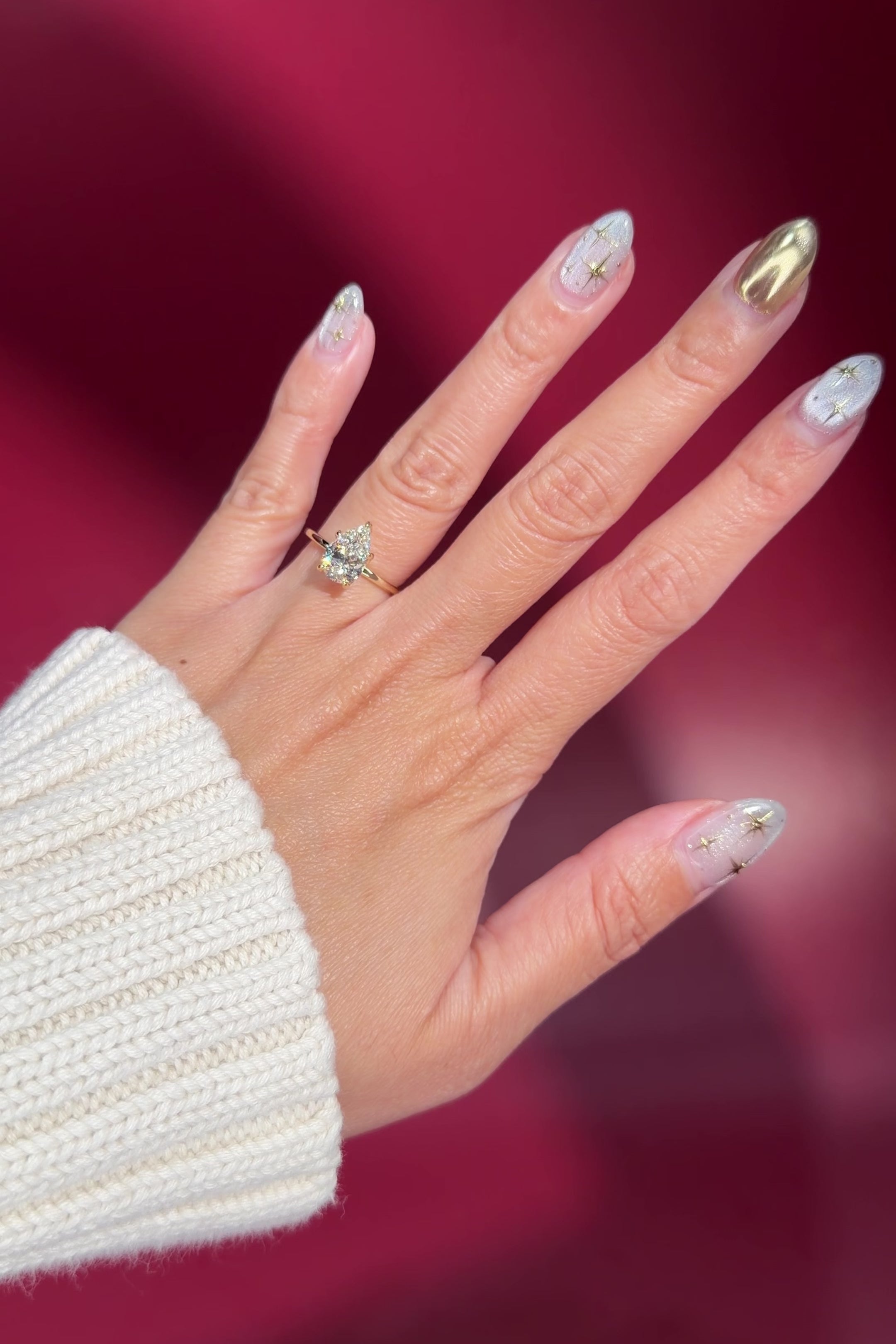 pear lab diamond solitaire engagement ring with flower petal prong basket yellow gold on hand