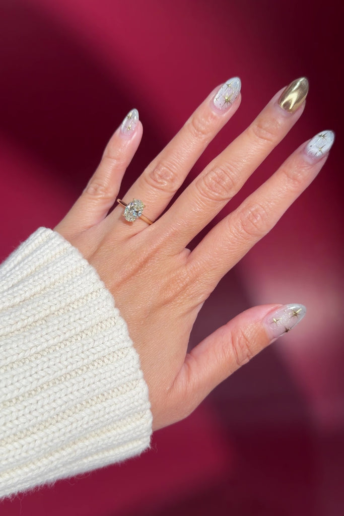 oval lab diamond yellow gold high polish engagement ring with cathedral and hidden halo on hand