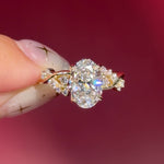 oval lab diamond cluster side stones whimsical yellow gold engagement ring