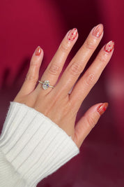 oval lab diamond engagement ring pavé diamond band with diamond prongs and diamond bridge classic yellow gold cathedral on hand