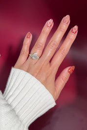 3.03ct pear lab diamond engagement ring cluster side stones whimsical yellow gold with petal prong basket on hand