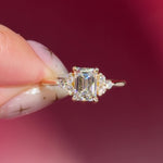 emerald lab diamond engagement ring trio side stone cluster yellow gold