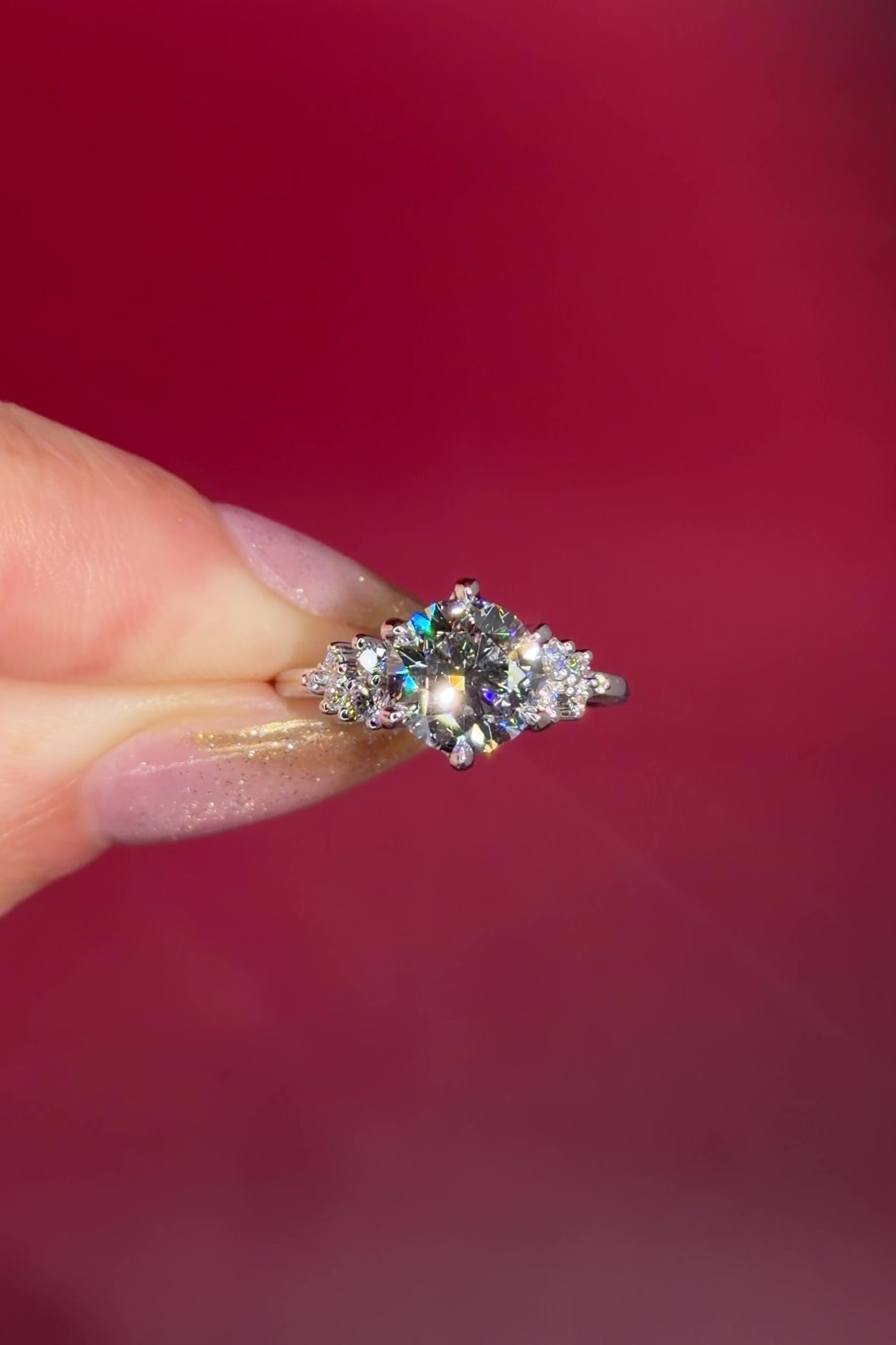 2.00ct D-VVS1 Round Lab Diamond Nova. This is a traditional body engagement ring featuring organic cluster side diamonds that resemble star dust or baby's breath. The center stone is held by our signature petal prongs.