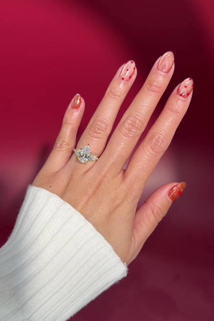 3.04ct pear lab diamond cluster side stone nature inspired whimsical engagement ring with flower petal prong basket yellow gold on hand