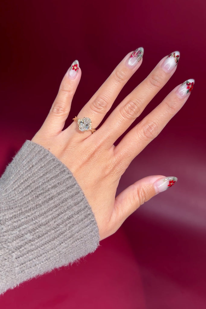 oval lab diamond nature inspired twist band engagement ring yellow gold cluster side stone setting on hand