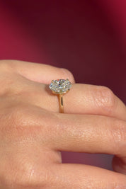 classic oval lab diamond solitaire engagement ring yellow gold cathedral setting petal prong basket on hand