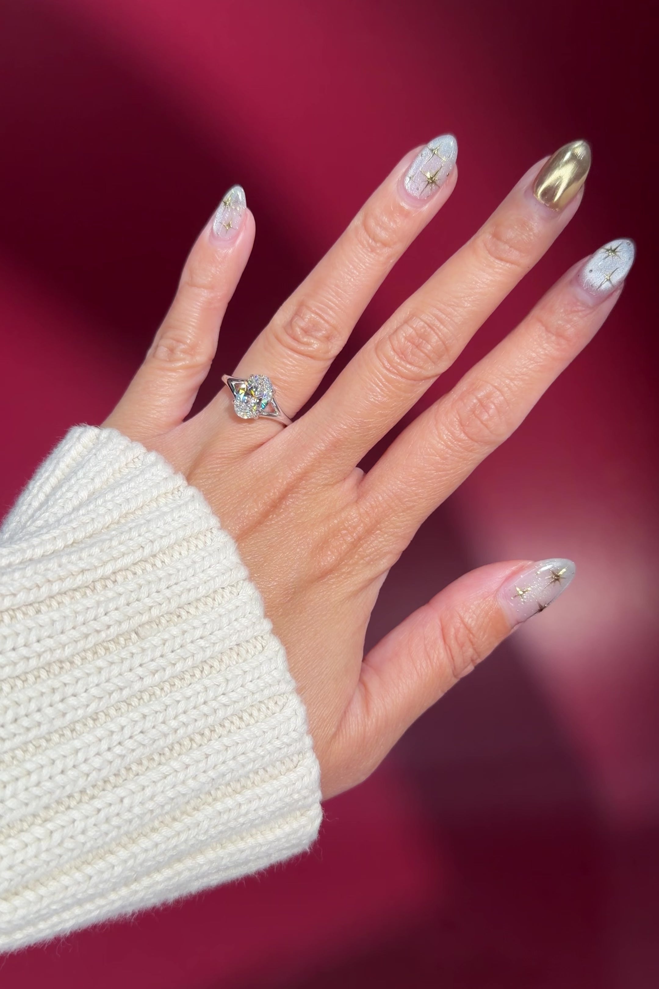 oval lab diamond white gold solitaire split shank engagement ring on hand