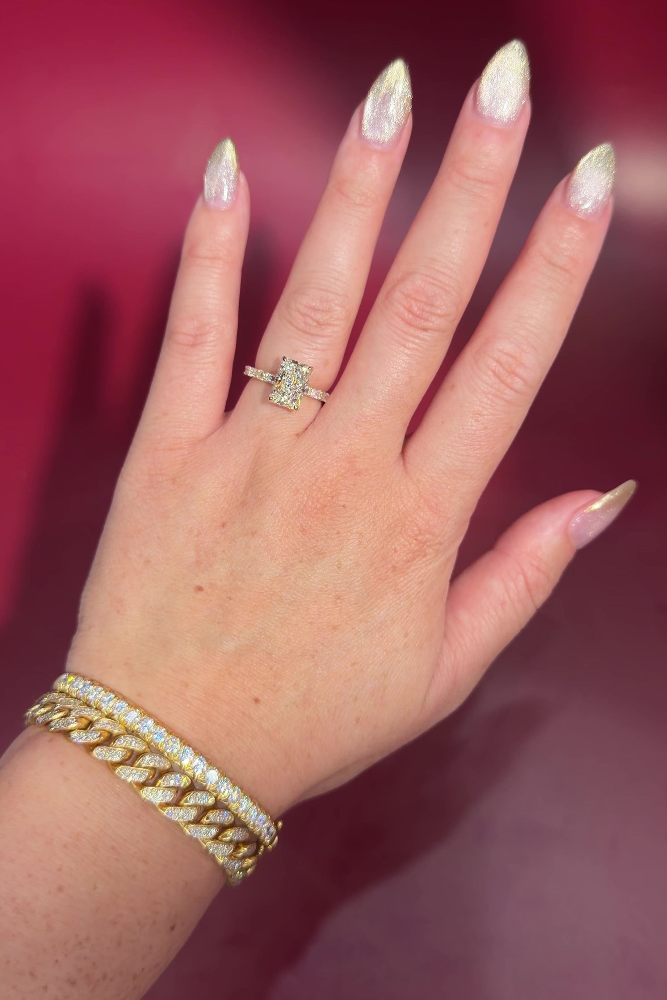 2.74ct E-VS1 Radiant Lab Diamond East West Ring. This is a traditional style engagement ring featuring a wrap under halo and east west radiant cut lab diamonds set into the band. The entire ring is made in solid 14k yellow gold.