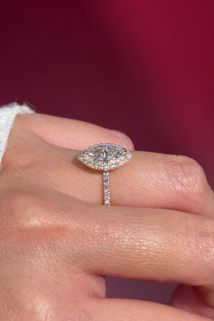 marquise lab diamond halo engagement ring with diamond petal prong basket on hand