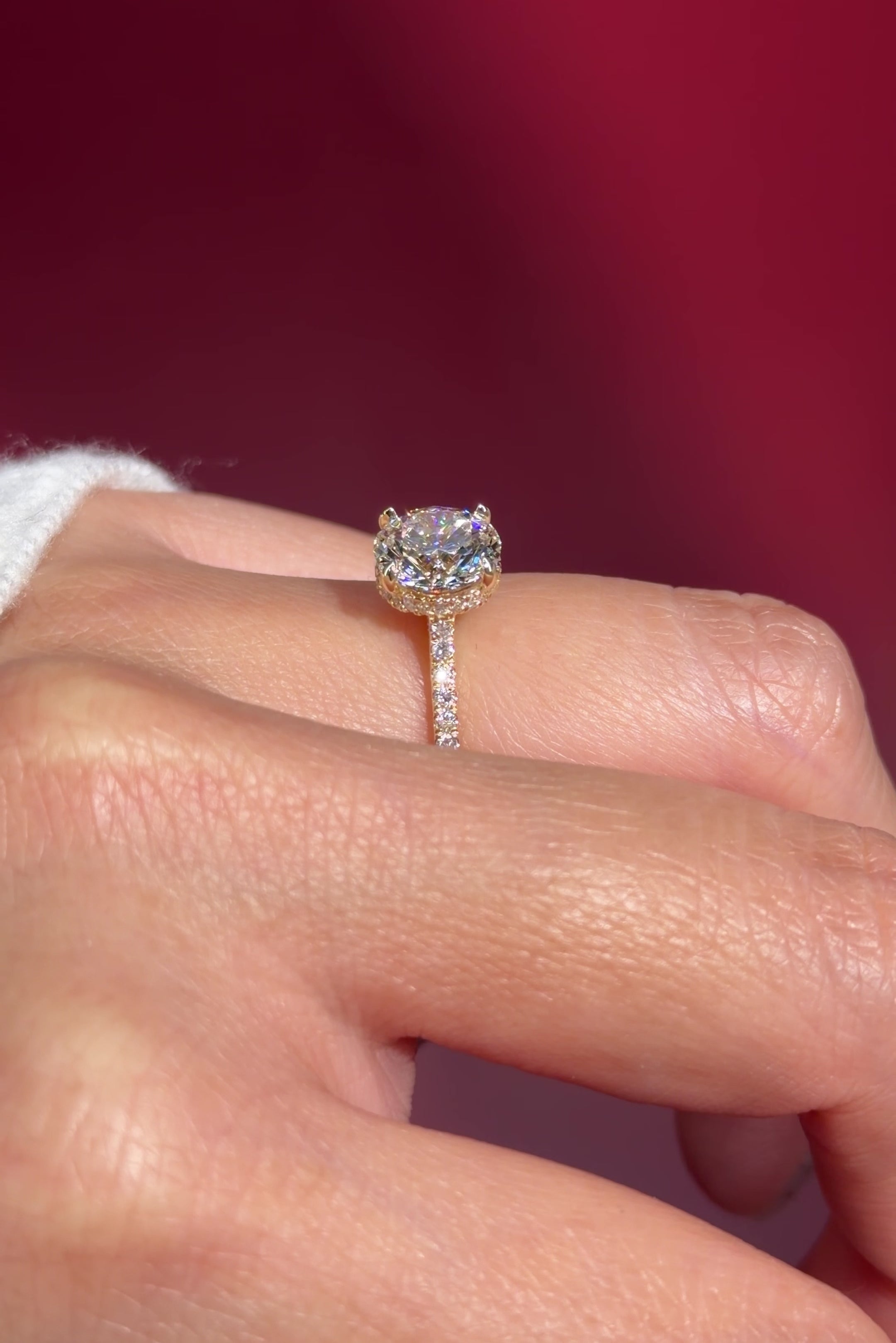 round lab diamond yellow gold engagement ring pavé with cathedral and diamond bridge and diamond prongs on hand