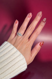 2.01ct e-vvs2 oval lab diamond whimsical cluster side stones white gold engagement ring with petal prong basket on hand