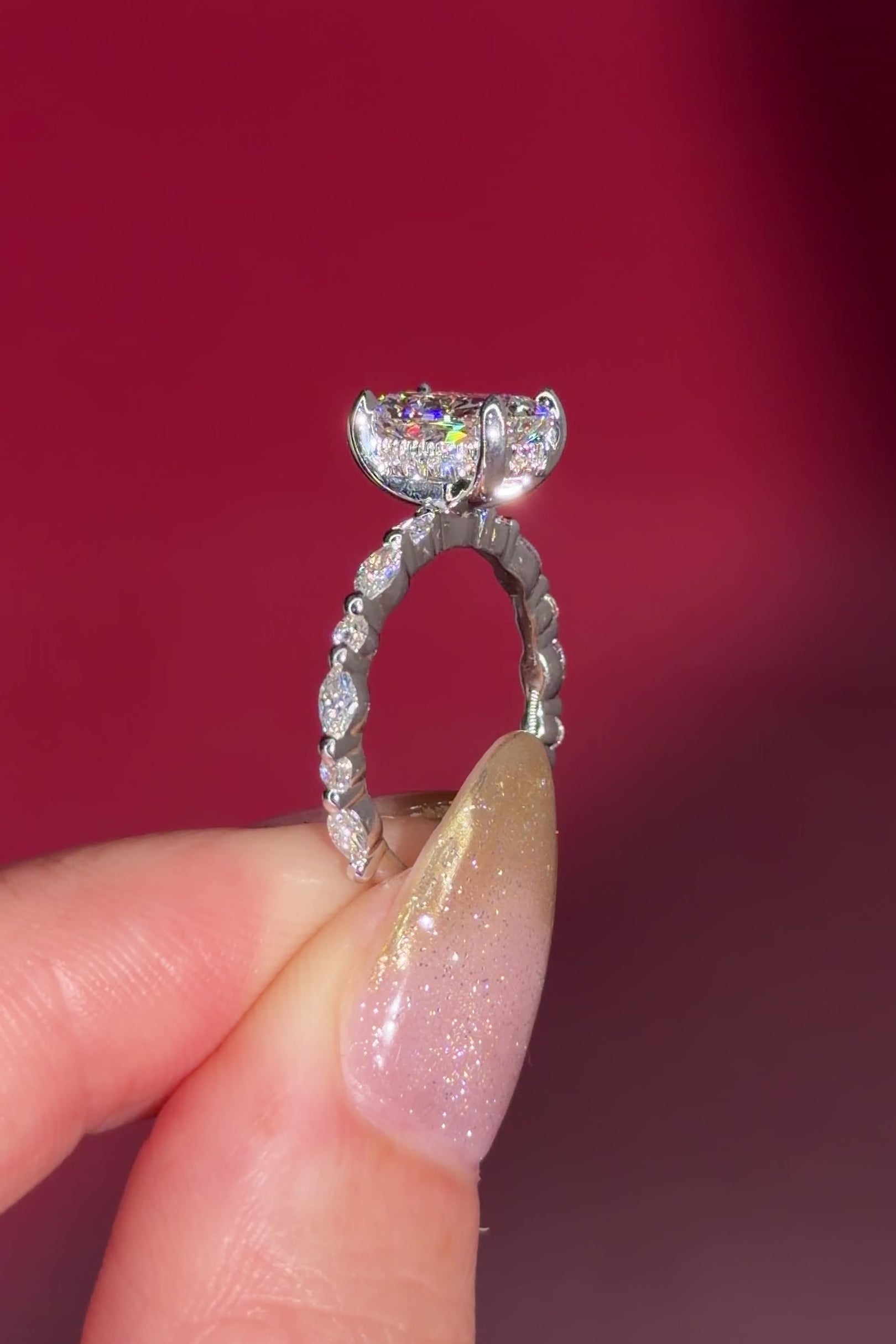 The Rei is a traditional style engagement ring featuring a hidden halo set between the prongs, adding subtle sparkle beneath the center stone.

The standout detail of this design is the floating marquise and round side diamonds, each held by a single prong. This setting allows each side diamond to be fully visible from every angle, creating a light, airy, and elegant look.

Because of this construction, Rei is a more delicate and high maintenance style, best suited for those who are mindful with daily wear 