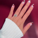 marquise diamond cluster white gold engagement ring on hand