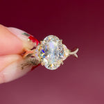 oval lab diamond nature inspired twist band engagement ring yellow gold cluster side stone setting