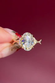 oval lab diamond nature inspired twist band engagement ring yellow gold cluster side stone setting