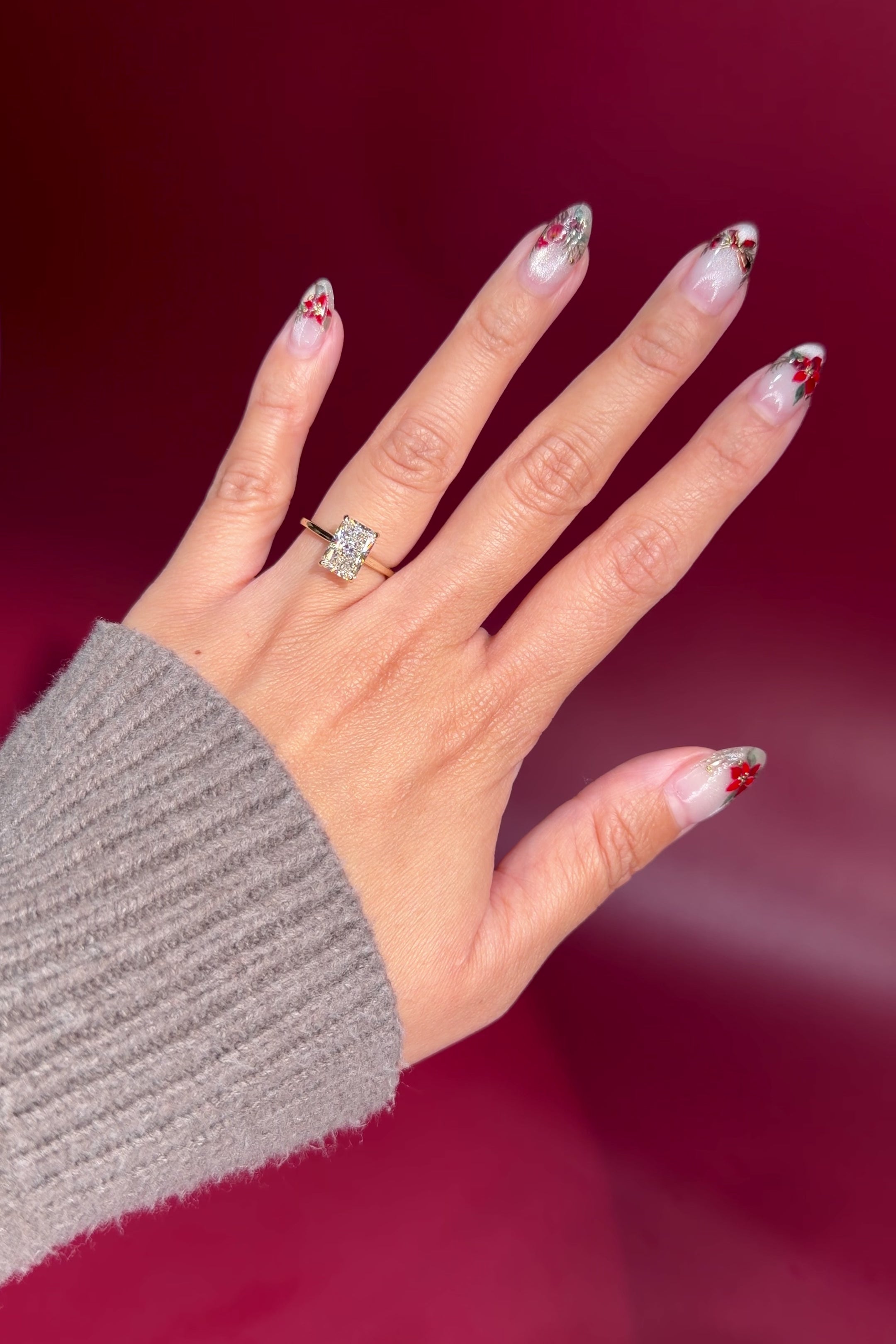 radiant lab diamond yellow gold solitaire engagement ring cathedral setting with diamond bridge on hand