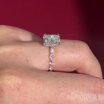 The Rei is a traditional style engagement ring featuring a hidden halo set between the prongs, adding subtle sparkle beneath the center stone.

The standout detail of this design is the floating marquise and round side diamonds, each held by a single prong. This setting allows each side diamond to be fully visible from every angle, creating a light, airy, and elegant look.

Because of this construction, Rei is a more delicate and high maintenance style, best suited for those who are mindful with daily wear 