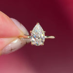 pear lab diamond solitaire engagement ring with flower petal prong basket yellow gold