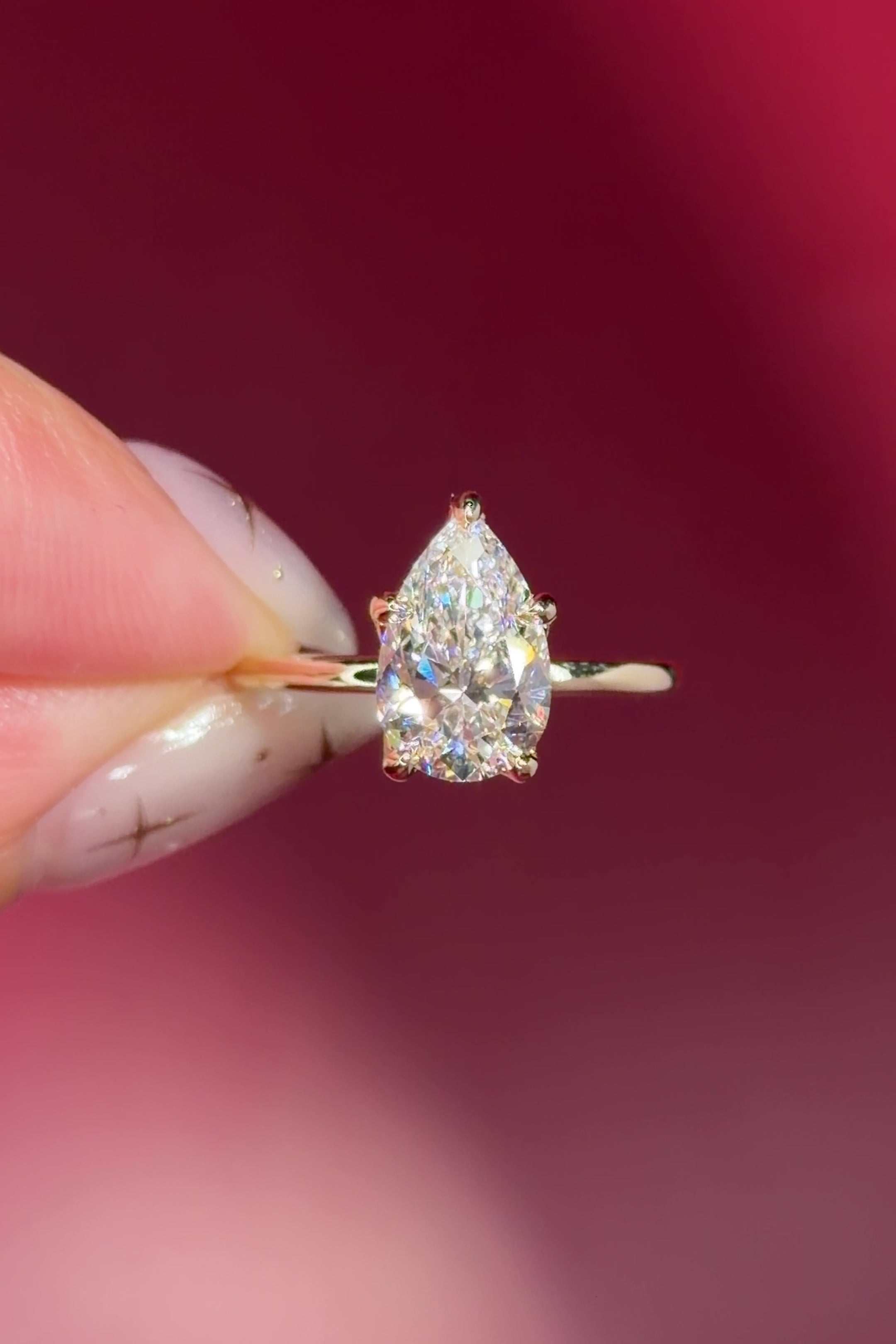 pear lab diamond solitaire engagement ring with flower petal prong basket yellow gold