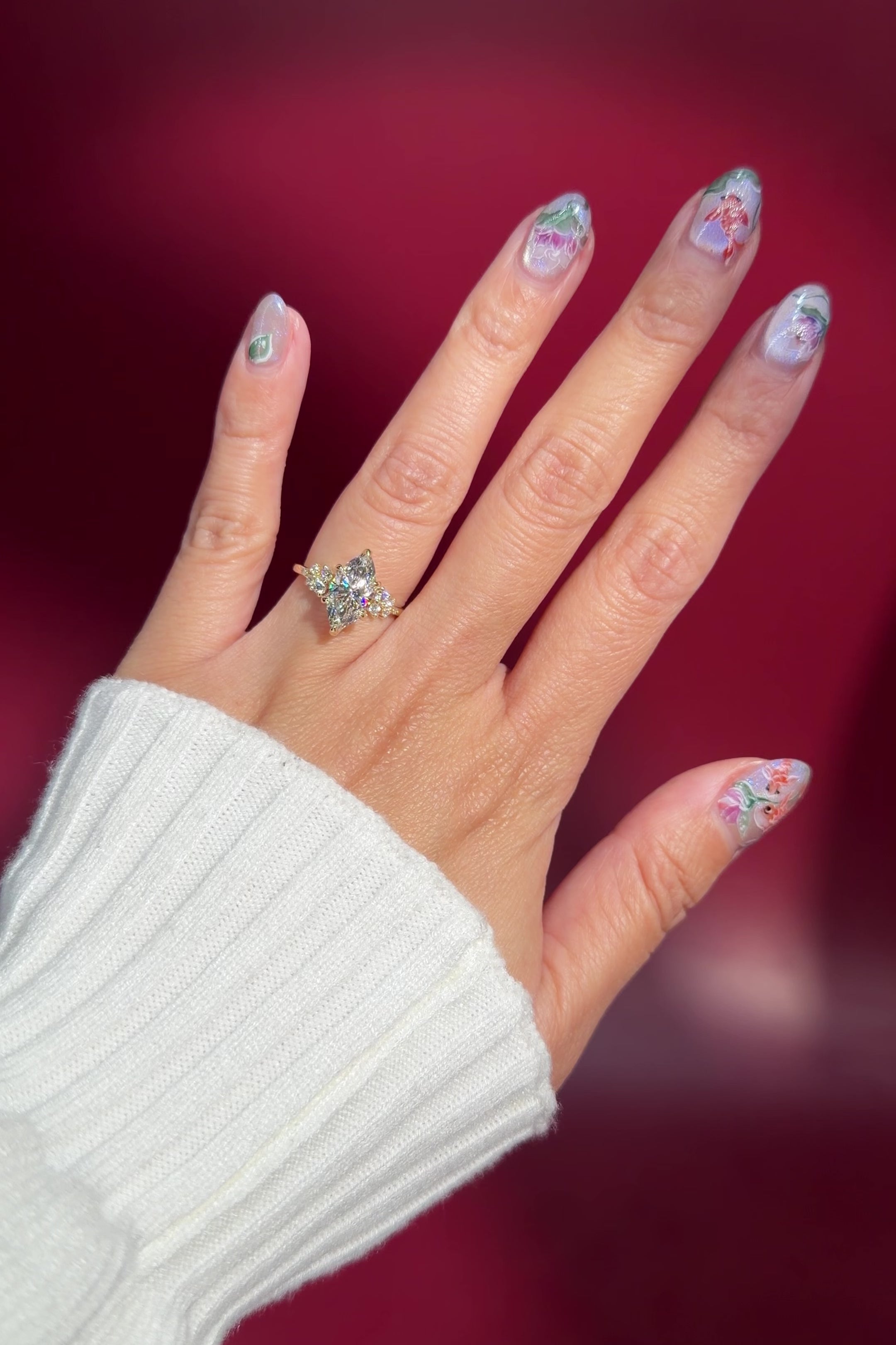 marquise lab diamond cluster side stone nature inspired engagement ring yellow gold setting on hand