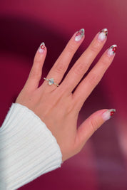 oval floating diamond spaced out band yellow gold engagement ring on hand