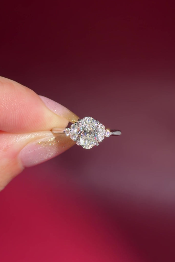 1.01ct D-VS1 Oval Lab Diamond Lindsey. The Lindsey features a classic high polish band with a trio of diamond side stones to perfectly accent your selected center stone.