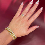 Round Solitaire Engagement Ring with Pavé Side Diamonds in yellow Gold with Petal Prongs on hand