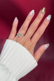 oval lab diamond cluster side stones whimsical yellow gold engagement ring on hand