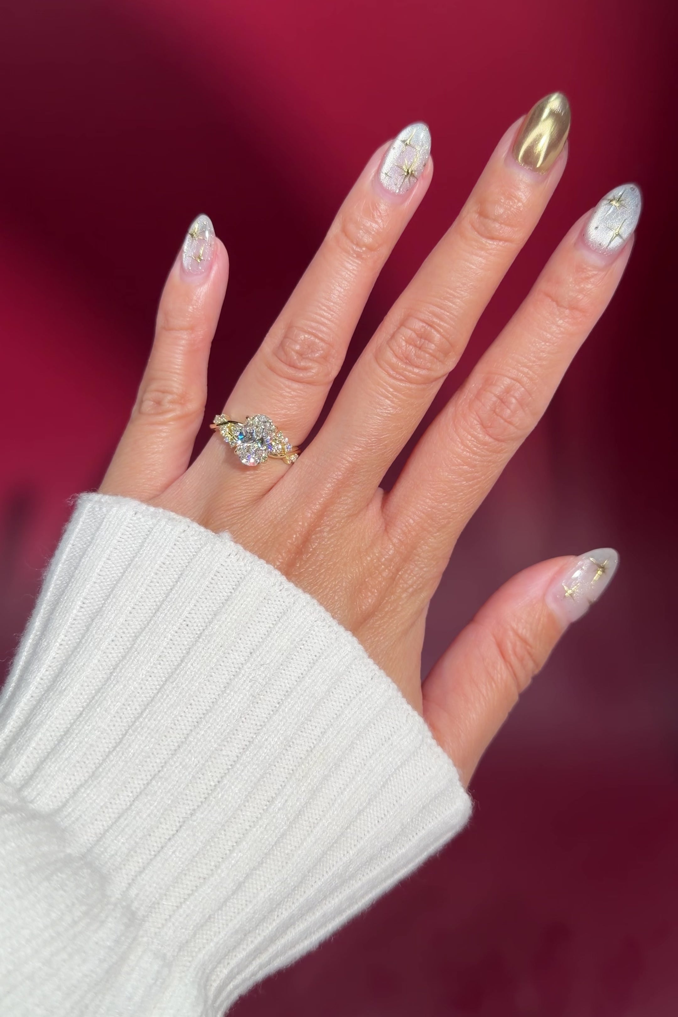 oval lab diamond cluster side stones whimsical yellow gold engagement ring on hand