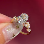 oval lab diamond cluster side stones whimsical yellow gold engagement ring