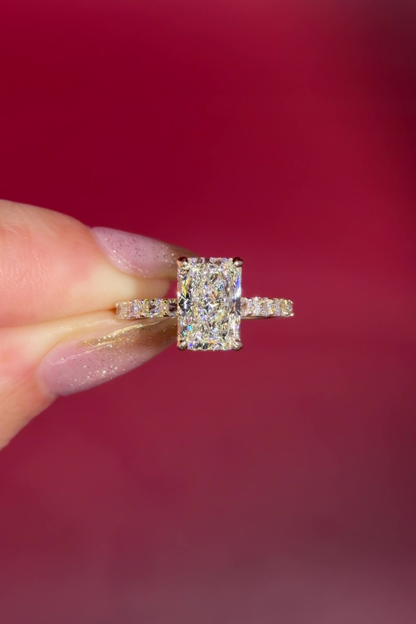 2.74ct E-VS1 Radiant Lab Diamond East West Ring. This is a traditional style engagement ring featuring a wrap under halo and east west radiant cut lab diamonds set into the band. The entire ring is made in solid 14k yellow gold.