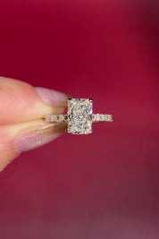 2.74ct E-VS1 Radiant Lab Diamond East West Ring. This is a traditional style engagement ring featuring a wrap under halo and east west radiant cut lab diamonds set into the band. The entire ring is made in solid 14k yellow gold.