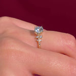 round yellow gold cluster petal prong engagement ring on hand
