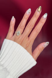 marquise lab diamond halo engagement ring with diamond petal prong basket on hand