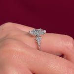 marquise diamond cluster white gold engagement ring on hand