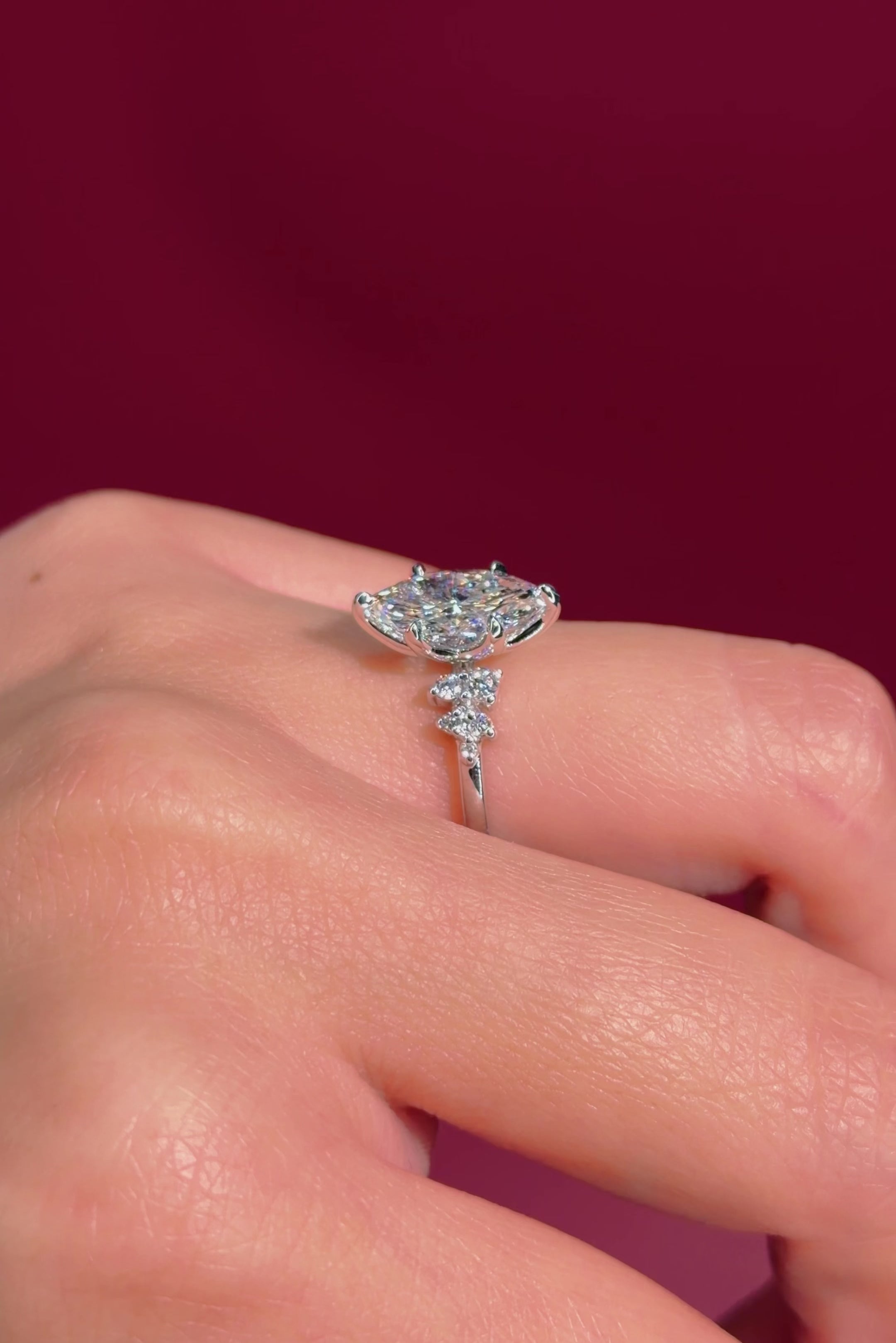 marquise diamond cluster white gold engagement ring on hand