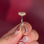 Oval solitaire with hidden halo and diamond bridge in yellow gold