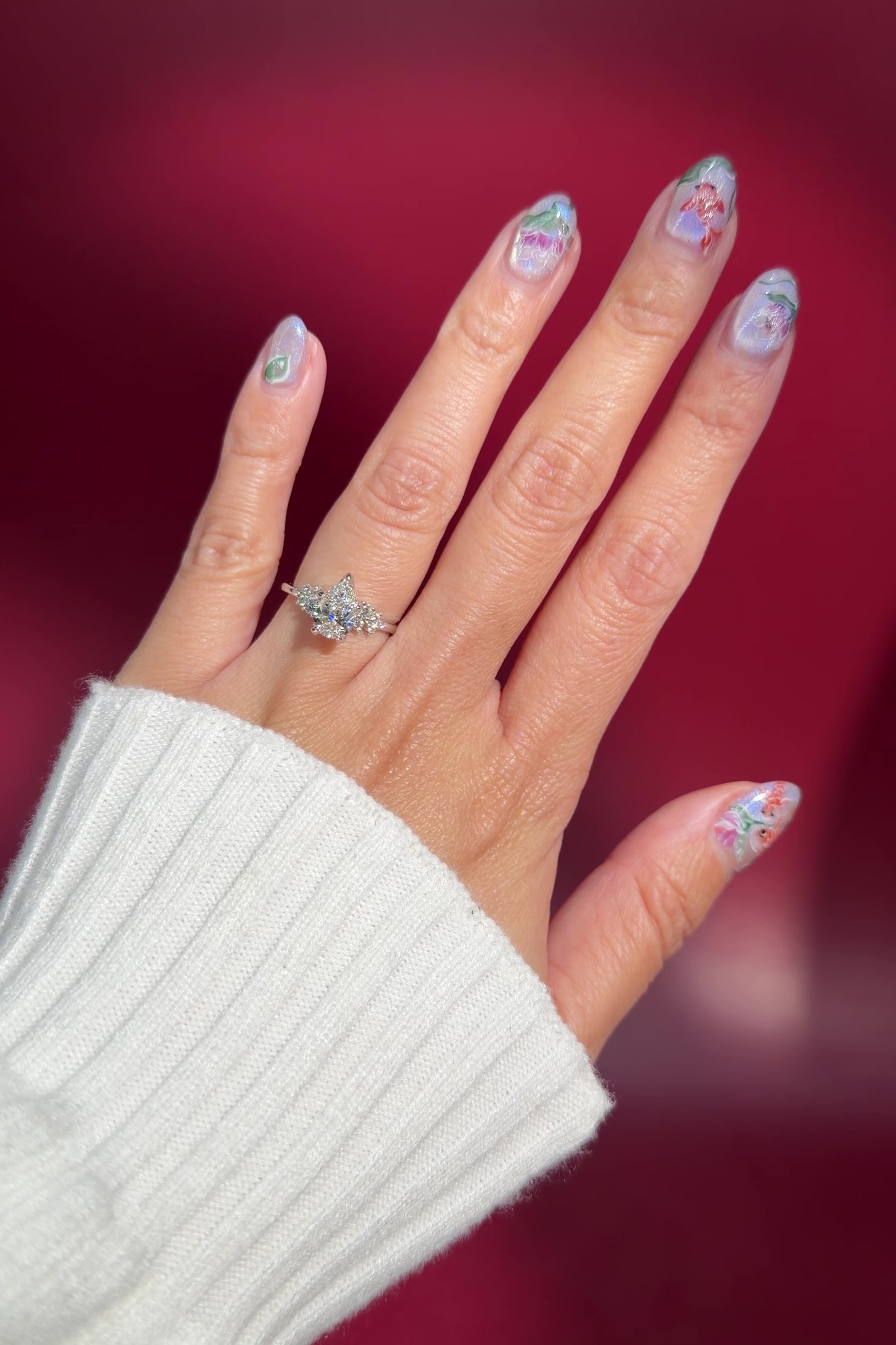 pear lab diamond cluster white gold nature inspired engagement ring with petal prong basket on hand