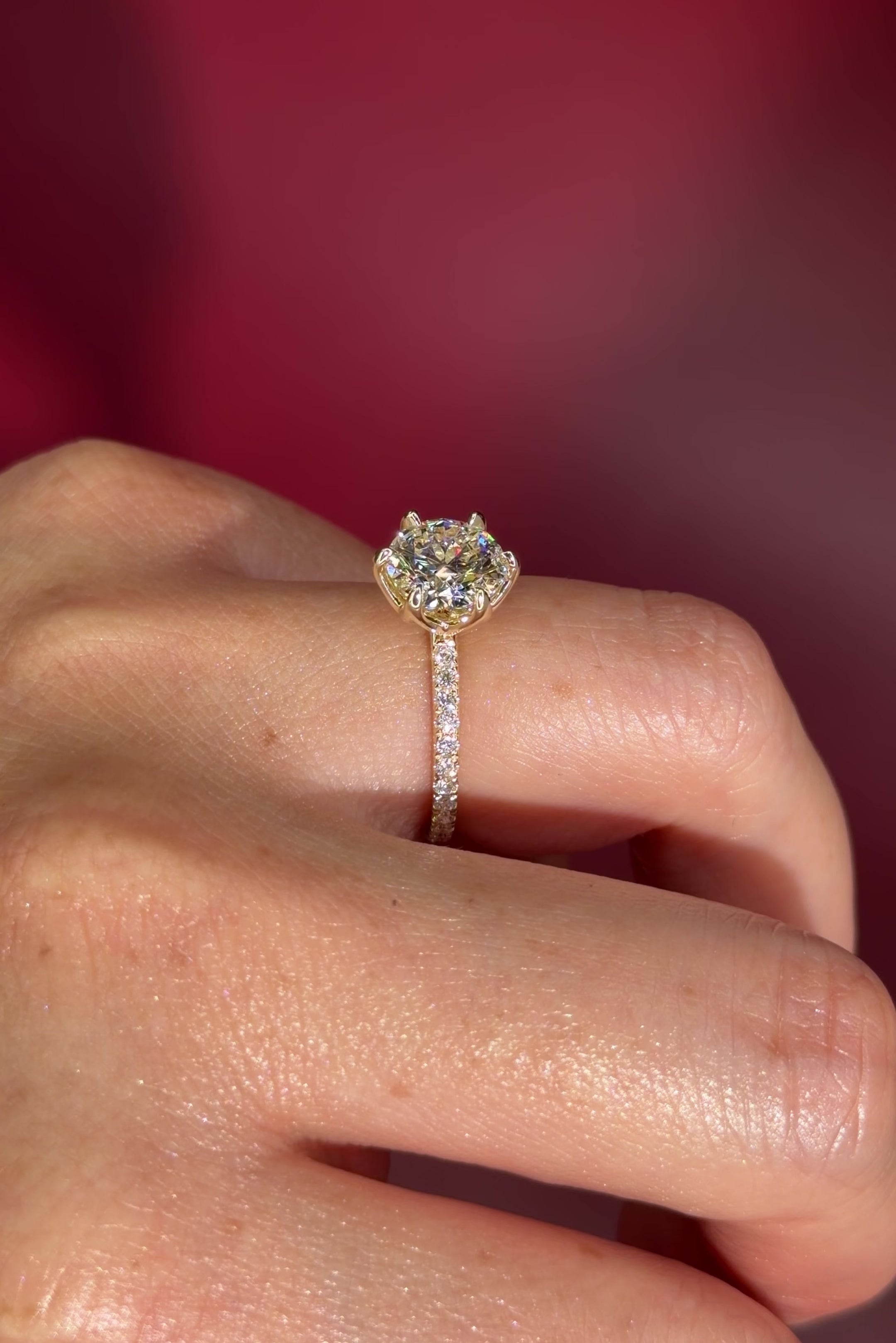 Round Solitaire Engagement Ring with Pavé Side Diamonds in yellow Gold with Petal Prongs