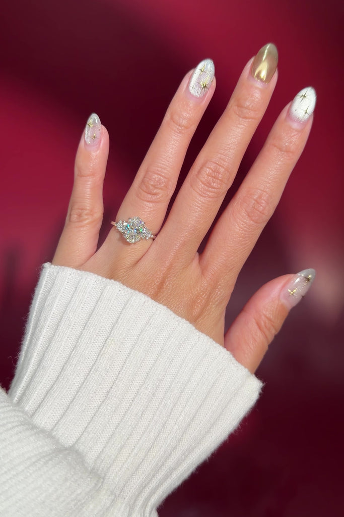 oval lab diamond engagement ring white gold side stones nature inspired cluster style on hand