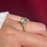 round lab diamond engagement ring leafy side marquise diamonds twist band engraved yellow gold on hand