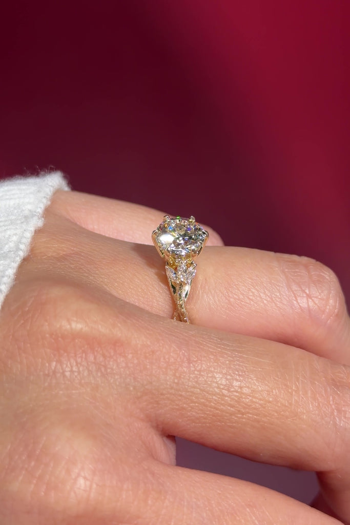 round lab diamond engagement ring leafy side marquise diamonds twist band engraved yellow gold on hand
