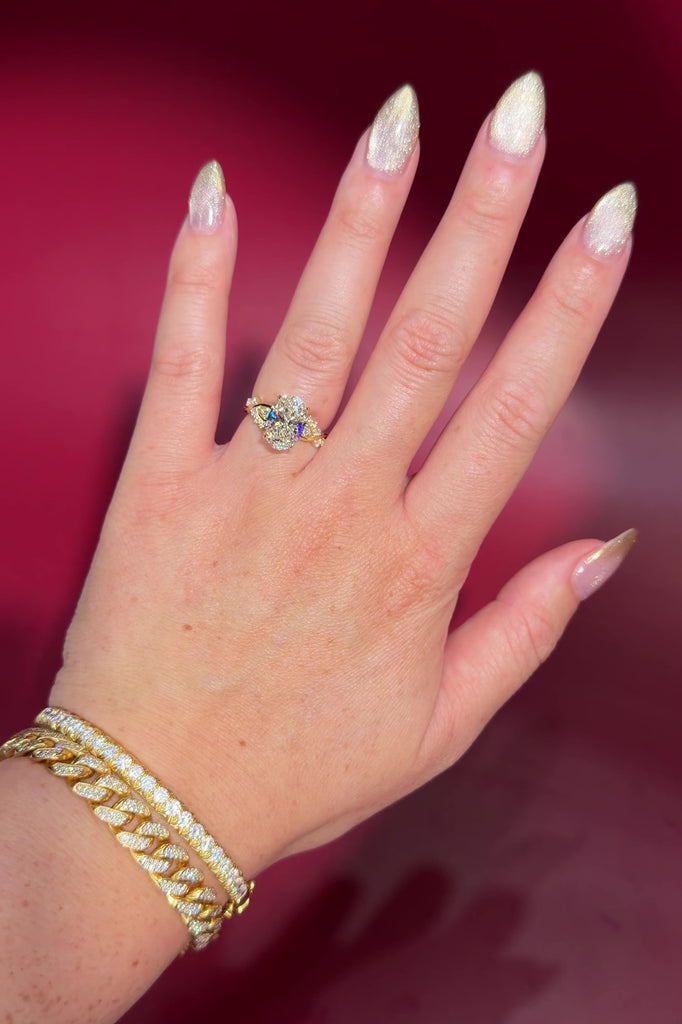 3.04ct E-VVS2 Oval Lab Diamond Ariel. The Ariel engagement ring is inspired by the sea. A unique twist on the classic Nova design, Ariel features a captivating center stone enveloped by wave-like contours. Delicate diamond bubble side stones, reminiscent of ocean bubbles, add a whimsical touch. Crafted precisely, this ring seamlessly blends timeless elegance with an underwater allure.