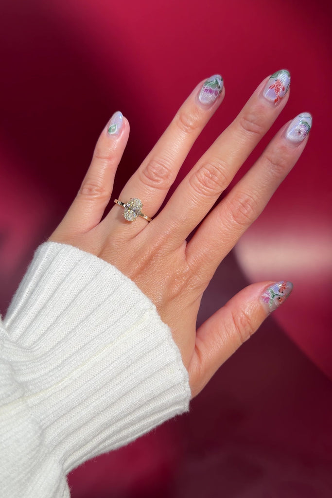 oval lab diamond engagement ring inlay style yellow gold band with hidden halo on hand