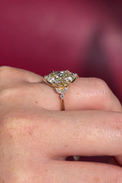 3.01ct F-VVS2 Marquise Lab Diamond Olivia. Three stone style engagement ring featuring two marquise and one round diamond at the bottom of the tro. The marquise act as diamond leaves holding the center stone. From the side profile the Olivia features a diamond bridge and diamond petal prongs.